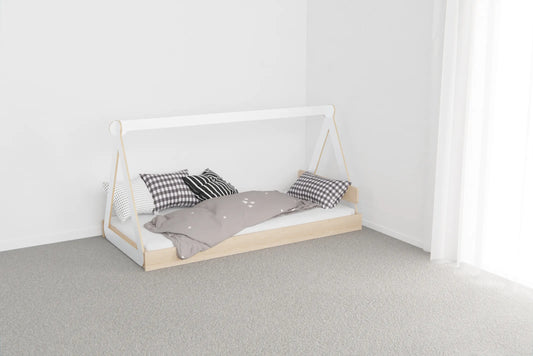 Low Montessori-style canopy floor bed made from NZ pine with birch plywood top, designed for safe independent sleep for young children