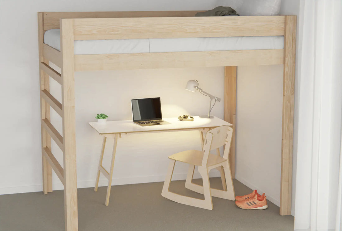 Loft bed with desk and chair underneath in a student room, featuring a whiteboard desk surface for planning and study