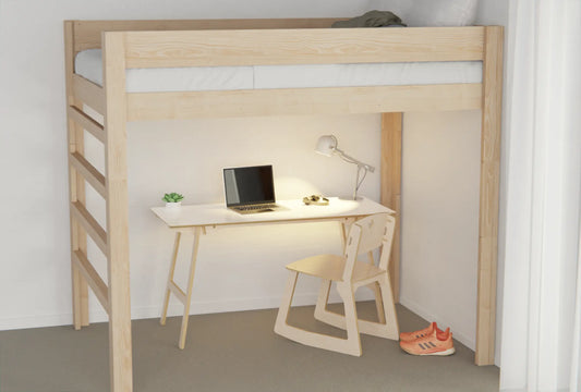 Loft bed with desk and chair underneath in a student room, featuring a whiteboard desk surface for planning and study