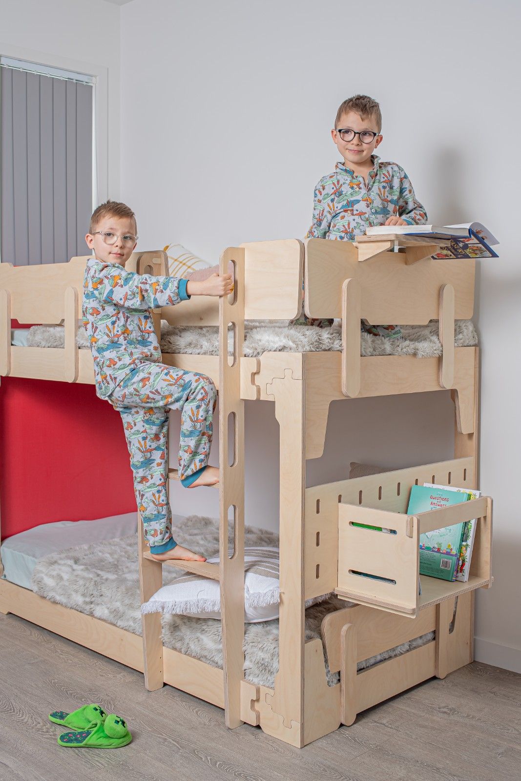 Siblings relaxing on an NZ-made KitSmart bunk bed in a bright shared kids’ room