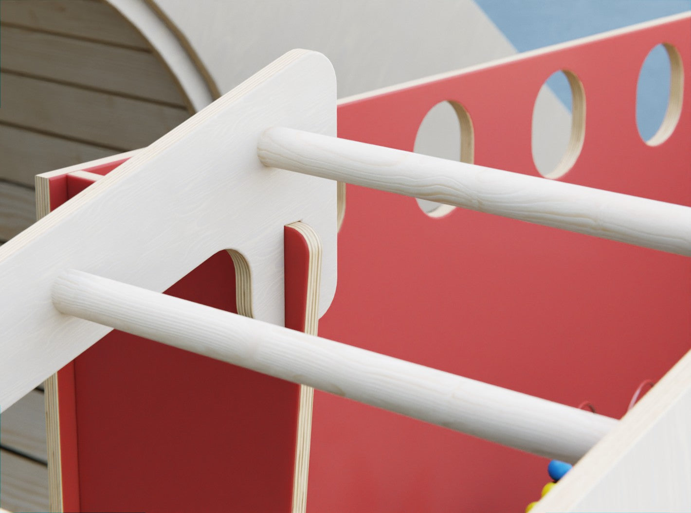 Kids climbing a safe and sturdy indoor playset with a built-in slide and activity drum