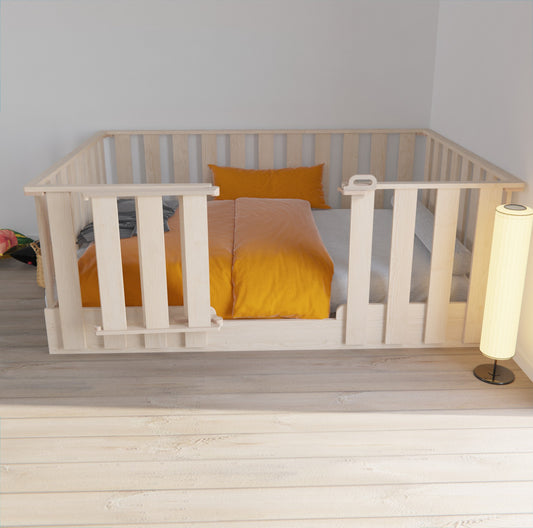 Montessori floor bed with high rails, designed for newborns and toddlers, offering a safe and adaptable sleeping space