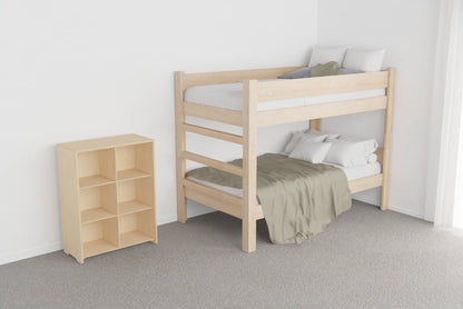 Low open shelf unit in birch plywood showing neatly organised toys, books and storage boxes in a kids’ room