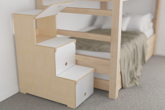 Birch plywood storage stairs with lift-up lids on each step, placed beside a kids’ bunk bed for safe climbing and hidden storage
