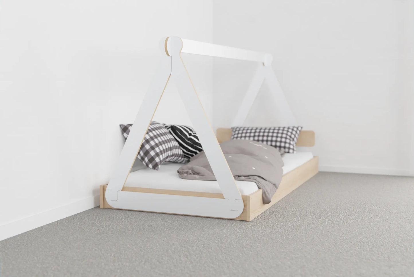Close-up of NZ pine kids’ canopy bed frame with smooth birch plywood canopy and low mattress sitting almost on the floor